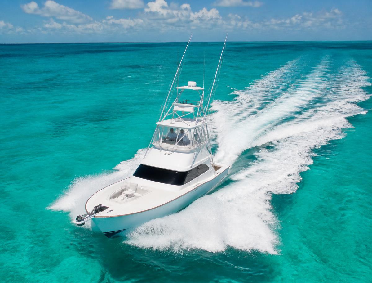 Charter fishing boat running across turquoise Gulf water